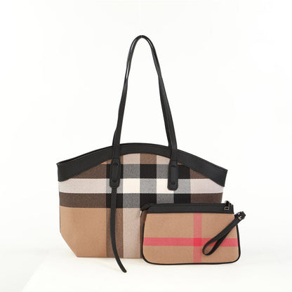 Alina's 2pc Rounded Handbag in white, black, tan and red chunky plaid with black faux leather rounded edging on top and matching double strap. Beside it is a small matching zippered pouch.