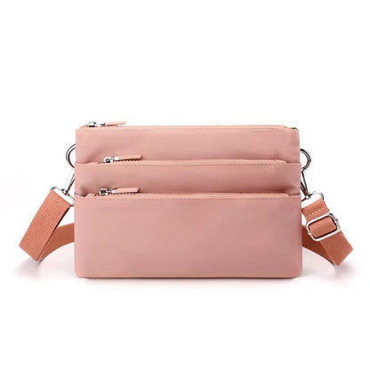 Alina's Triple Compartment RFID Crossbody in salmon, front view.