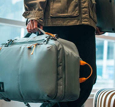 man carrying carry-on bag