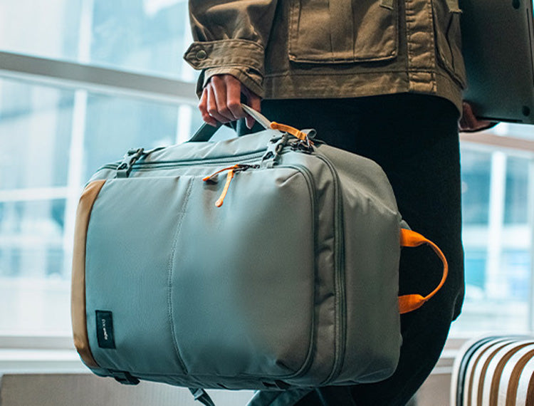 man carrying carry-on bag