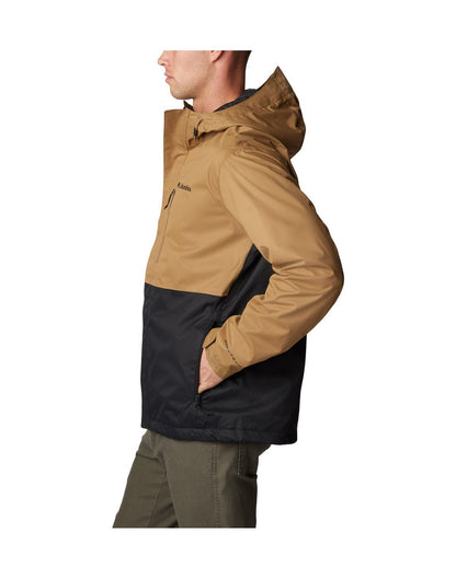 Left side view of a man wearing Columbia Men's Hikebound™ Rain Jacket in Delta black, zipped up with hand in side pocket.