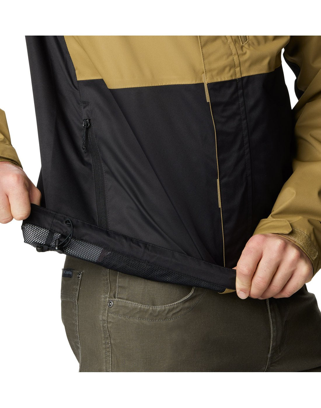 Right side close up view of a man wearing Columbia Men's Hikebound™ Rain Jacket in Delta black, hem rolled up to show adjustable drawcord.