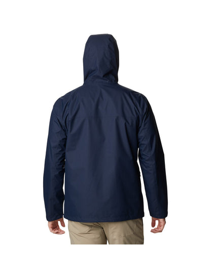 Back view of a man wearing Columbia Men's Hikebound™ Rain Jacket in Collegiate Navy with hood up.