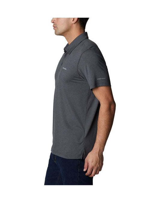 Product Image – Left side view of a man wearing Columbia Men's Tech Trail™ Polo Shirt in shark heather colour.