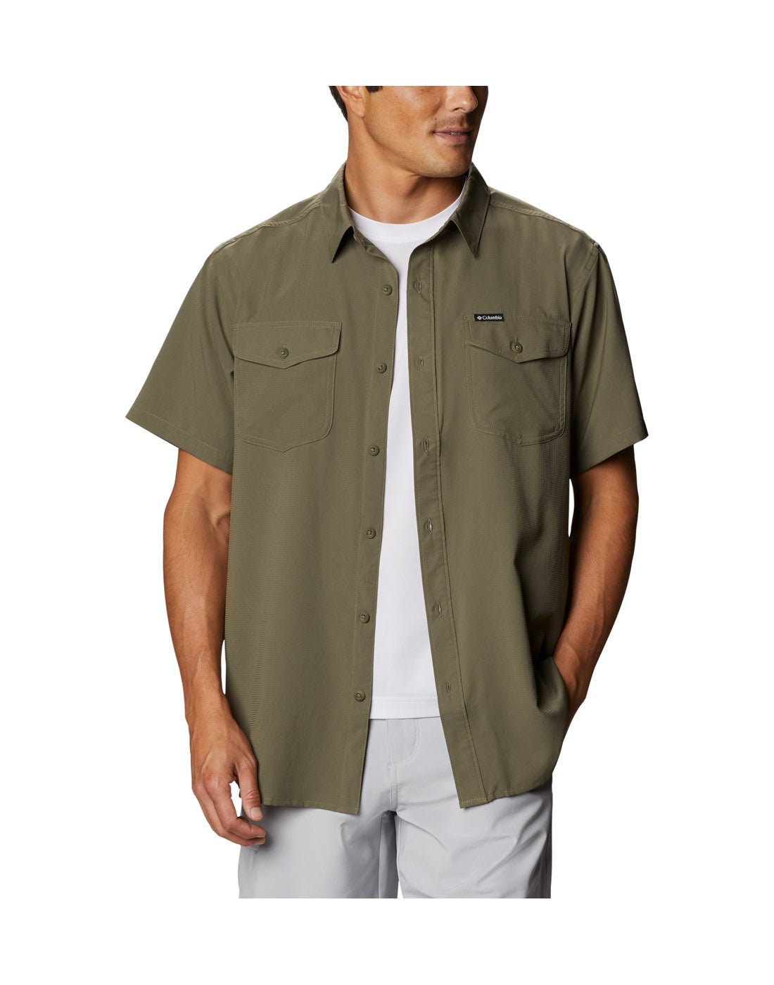 Man wearing a Columbia Men's Utilizer™ II Solid Short Sleeve Shirt in stone green colour. Shirt unbuttoned and wearing a white tee-shirt underneath.