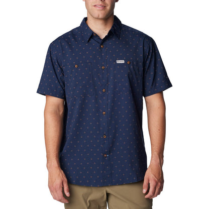 Man wearing khaki pants and Columbia Men's Utilizer™ Printed Woven Short Sleeve Shirt in collegiate navy dawn dot pattern, front view