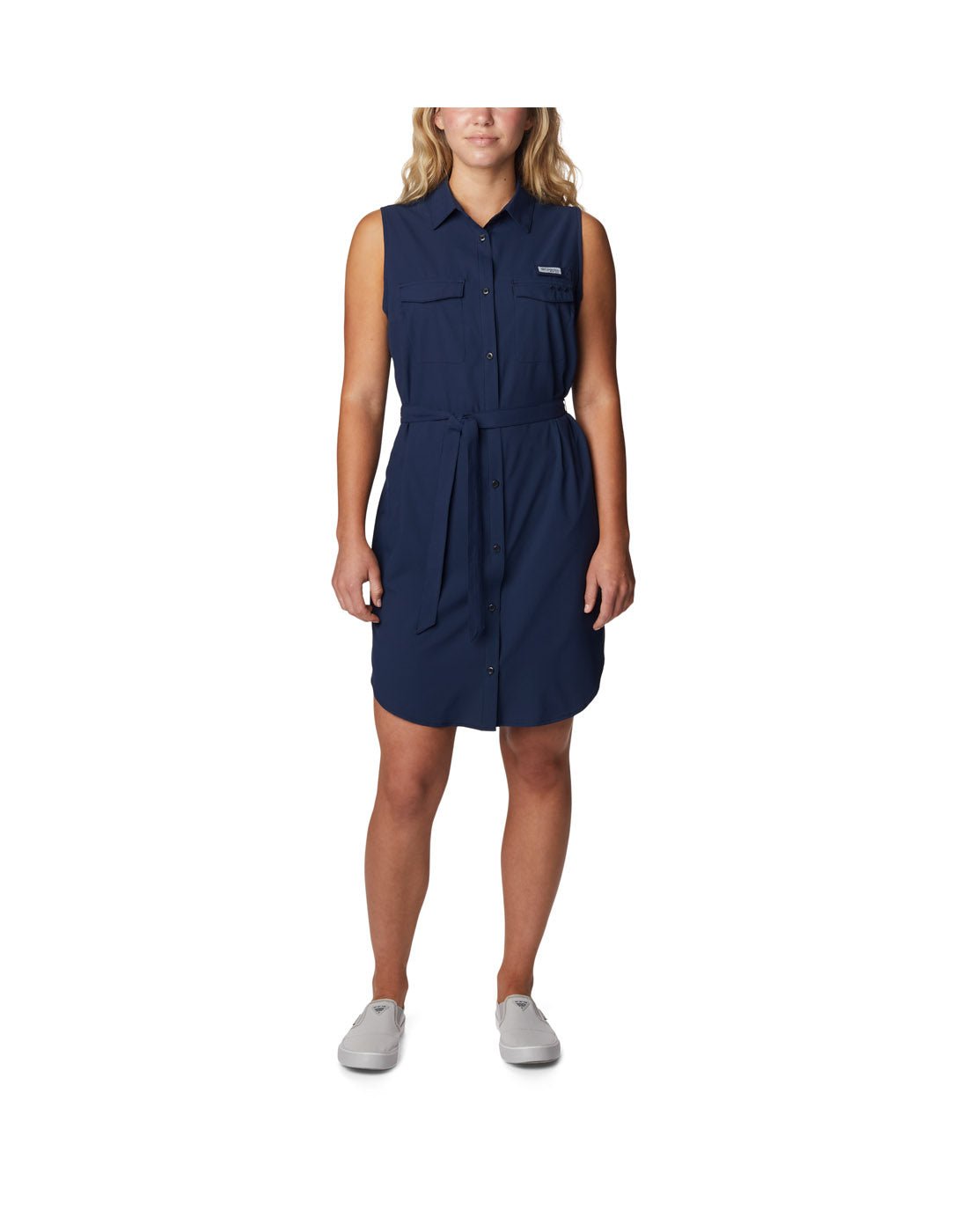 Woman wearing light grey running shoes and Columbia Women's PFG Sun Drifter™ Woven Dress II in collegiate navy, front view