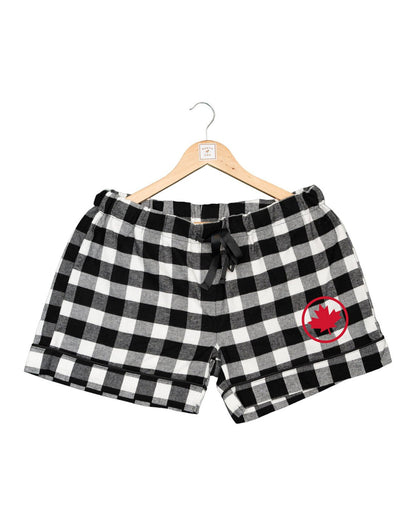 Unisex Plaid Sleep Shorts in black and white checkered pattern and red maple leaf in a circle on left thigh