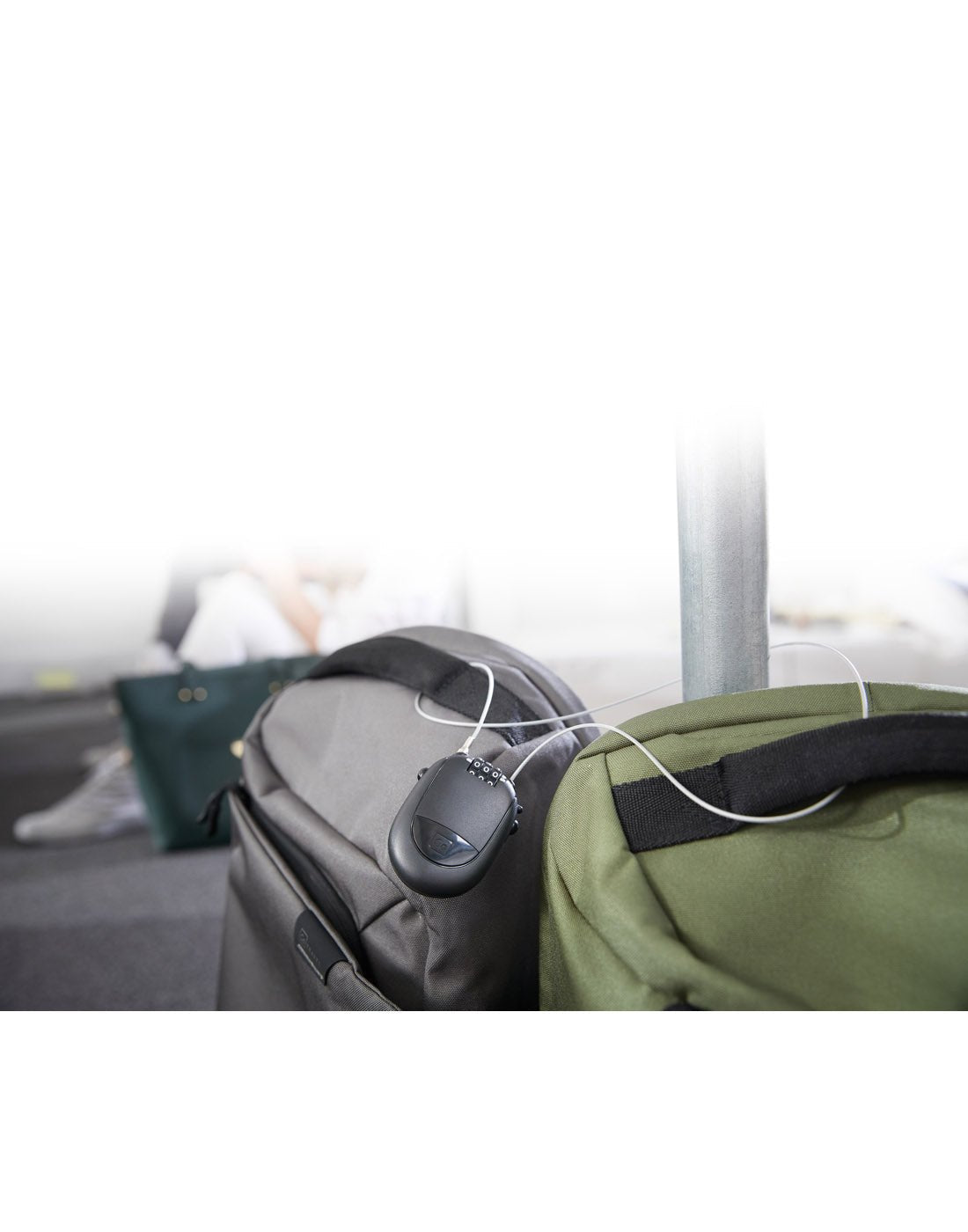 Lifestyle image of Go Travel Retractable Cable Padlock secured onto two bags.