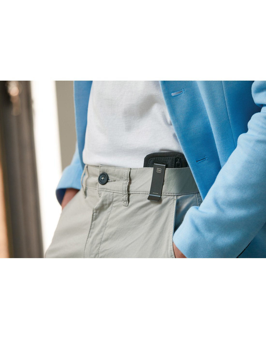 Lifestyle image of a person with hands in their pockets, Go Travel The Clip Pouch RFID clipped onto their  jeans. 