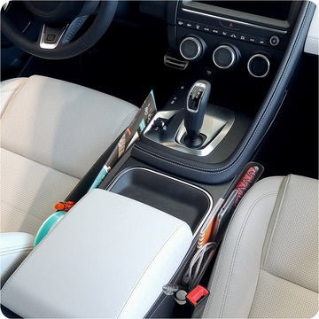 Lifestyle image of High Road® Car Seat Wedge Pocket - 2 pack, positioned beside the centre console of a car.