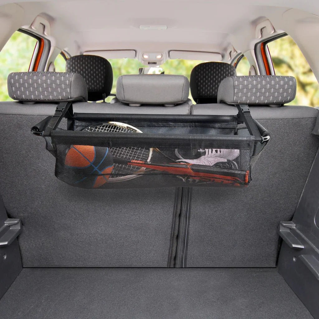 Lifestyle image of High Road® CargoStash™ Storage Shelf, positioned inside the trunk of a car, stored with sports equipment and gear.