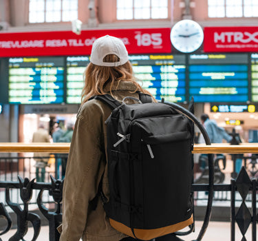 Women carrying backpack at airport