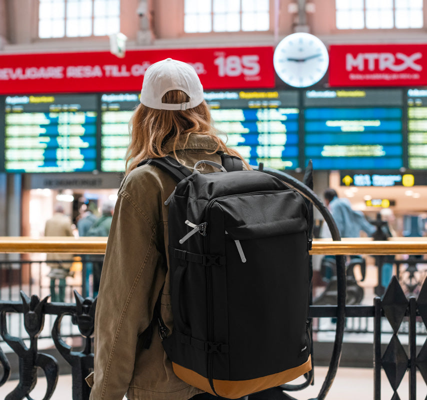 Women carrying backpack at airport