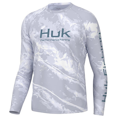 Front view of the Huk Men's Mossy Oak Pursuit Performance Shirt in Mossy Oak Stormwater Bonefish colour.  Huk logo printed across chest and "Huk Fishing" along  outside length of left sleeve.