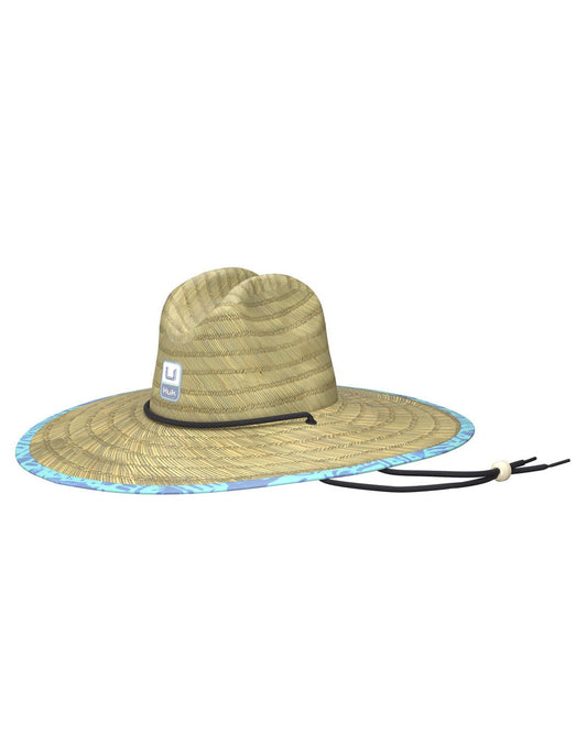 Product Image – Front view of the Huk Men's Straw Hat in Tiki Beach Marine Blue pattern liner. Showing the Huk logo on the front and the adjustable chin strap.