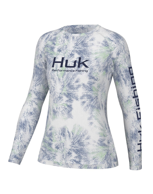 Product Image – Front view of the Huk Women's Pursuit Performance Shirt in Aqua Dye White colour. Huk logo printed across chest and "Huk Fishing" along outside length of left sleeve.