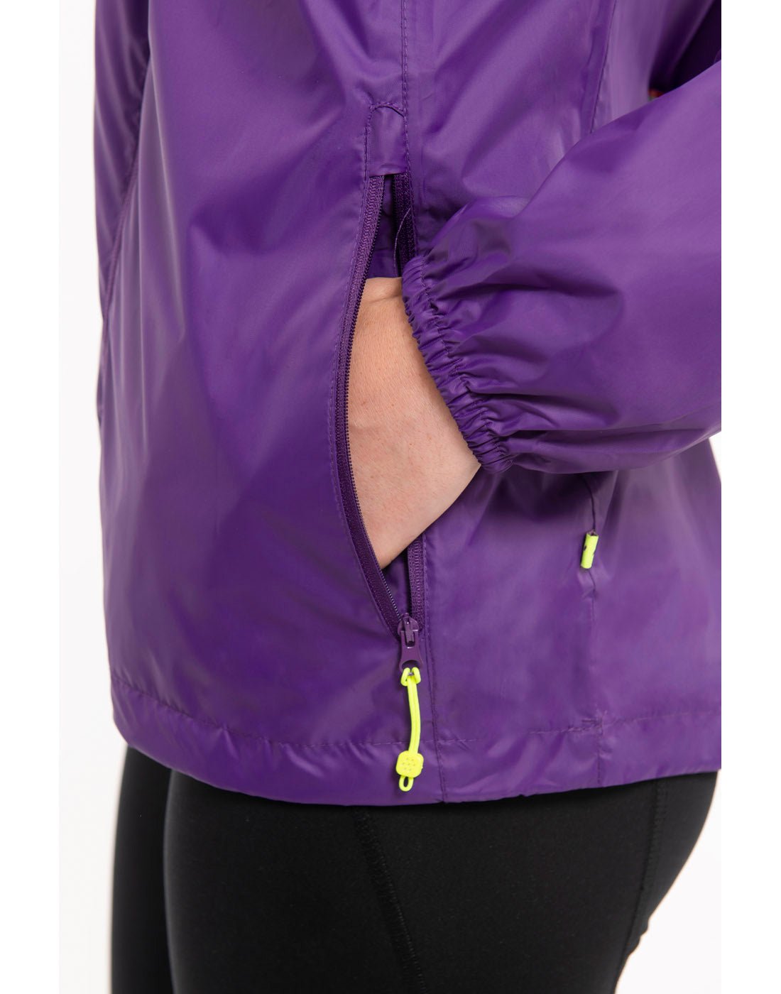 Close up of hands in pocket of purple Mac in a Sac Origin II Packable Waterproof Jacket.