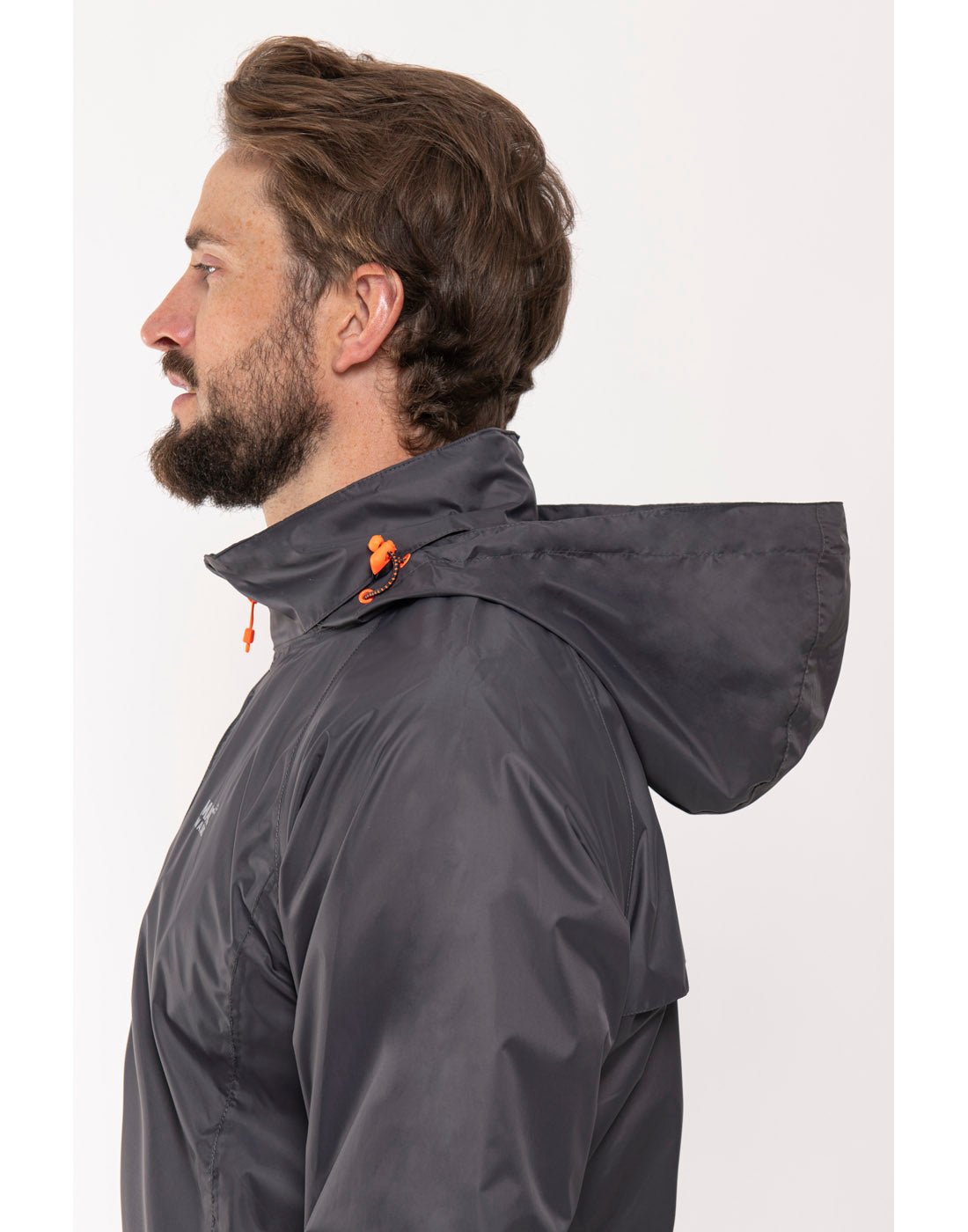 Man wearing Mac in a Sac Origin II Packable Waterproof Jacket in charcoal, close up side view.