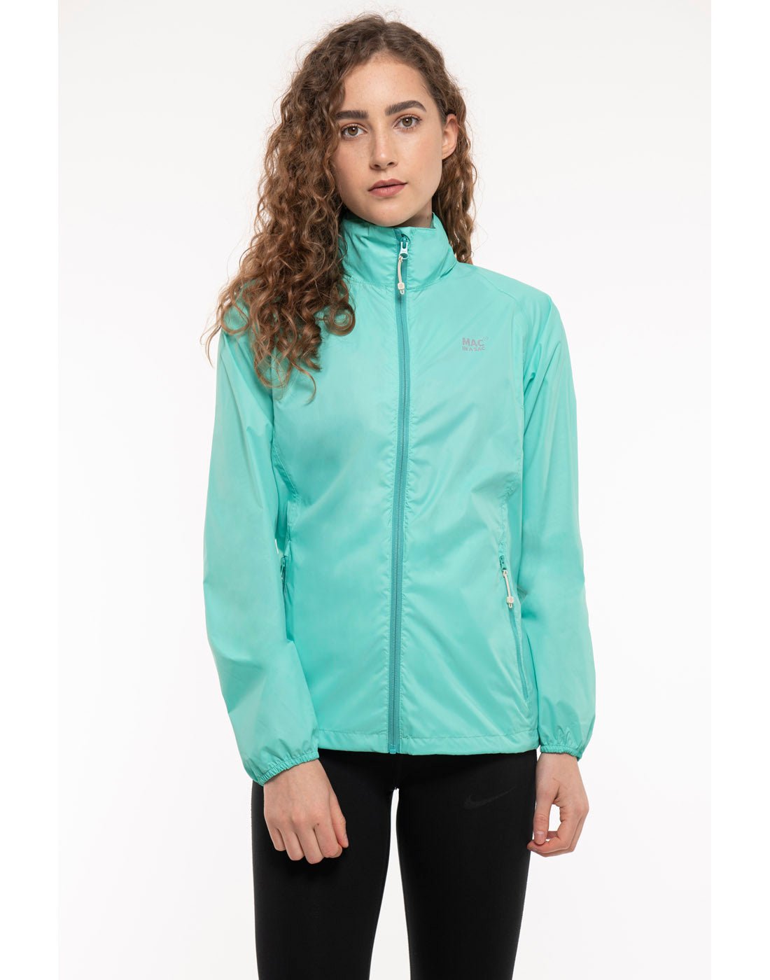 Woman wearing Mac in a Sac Origin II Packable Waterproof Jacket in tiffany, front view.