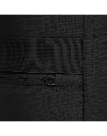 Close up of back zipper pull on jet black backpack, tucked into safety slot