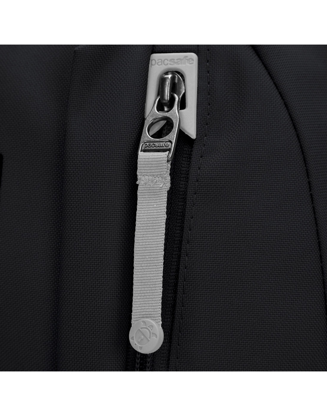 Close up of grey zipper pull in dock lock on black backpack