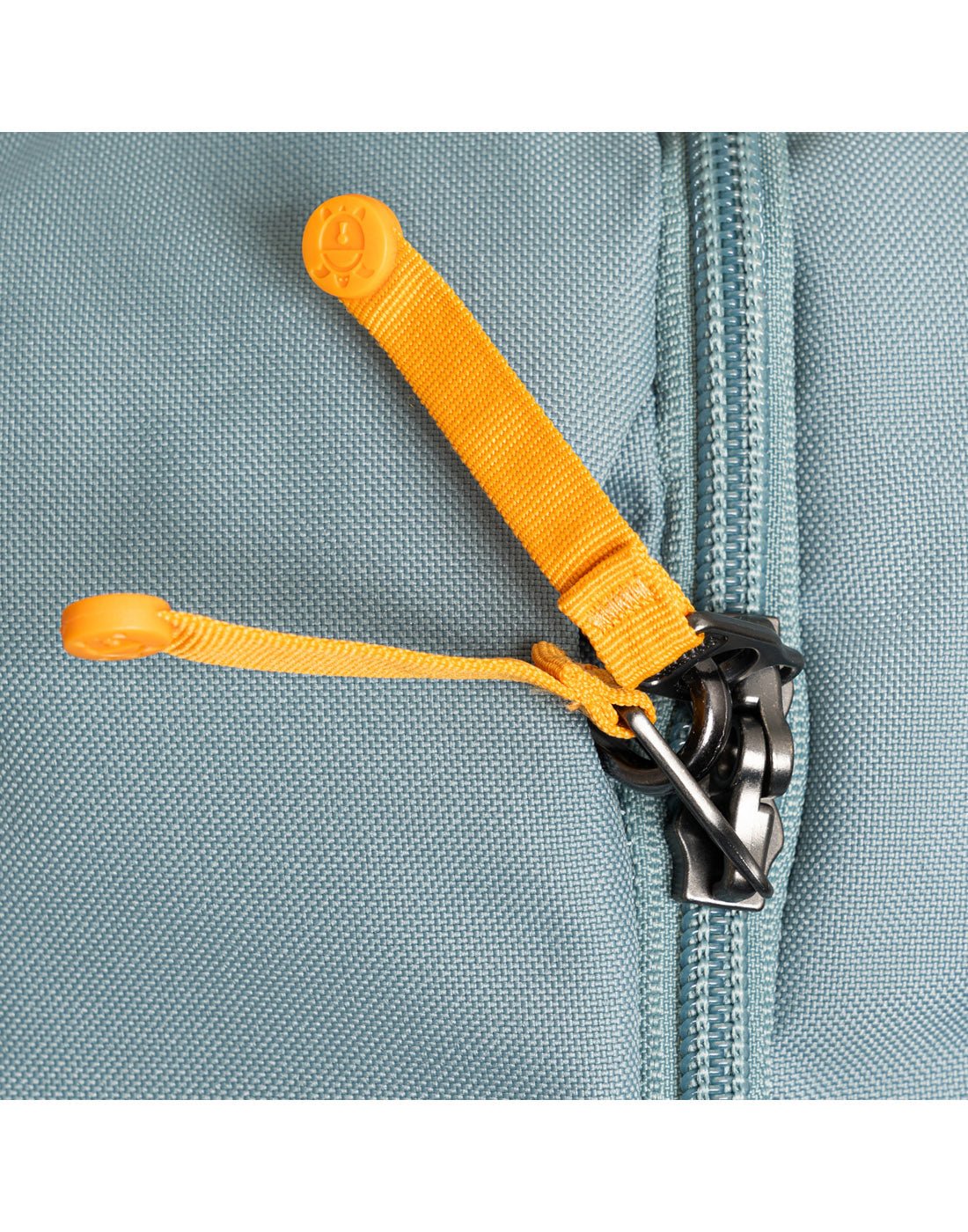 Close-up of an anti-theft lockable zip sliders and lock hole.