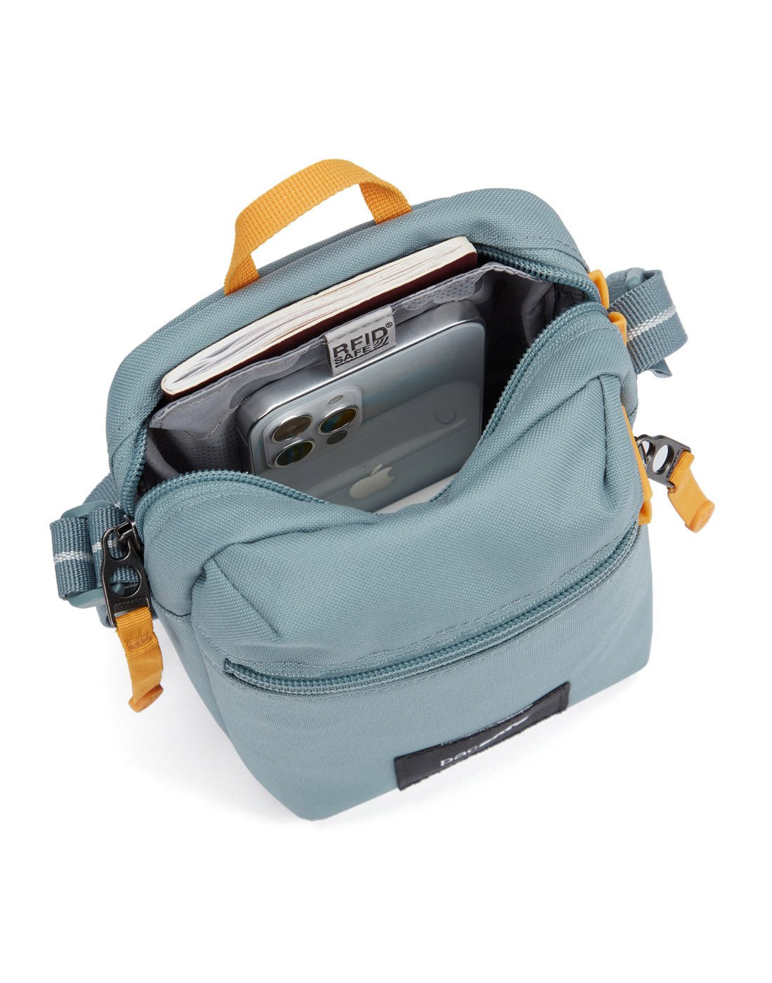 Pacsafe® GO Anti-Theft Micro Crossbody in mint green colour top view with zipper open showing bag interior and RFID blocking pocket.