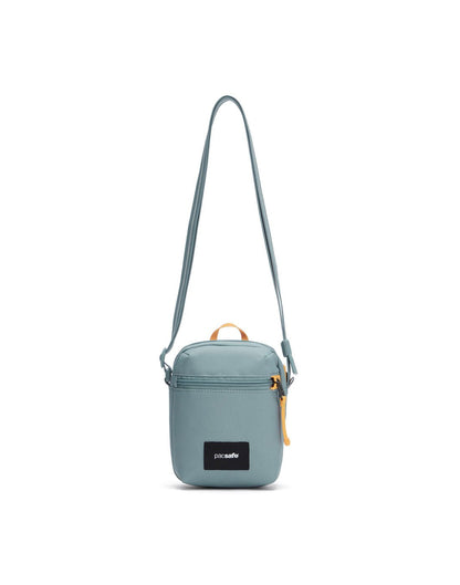 Pacsafe® GO Anti-Theft Micro Crossbody in mint green colour, front view with cut-resistant strap extended.