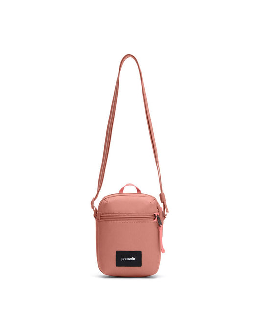 Product Image – Pacsafe® GO Anti-Theft Micro Crossbody in rose colour, front view with cut-resistant strap extended.