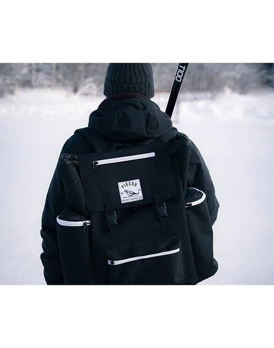 Product Image – Back of man walking in the snow with the Pigeon Pack on his back