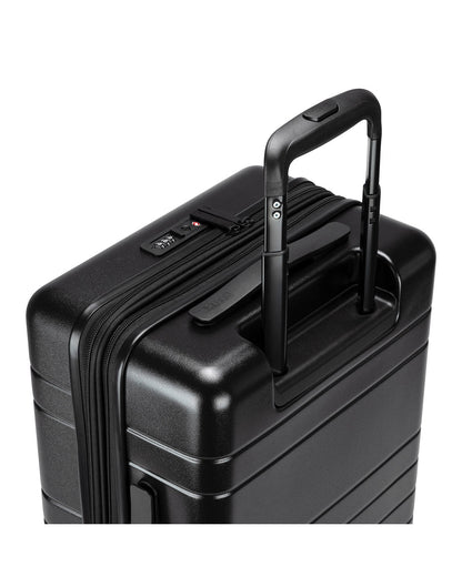 Roots Travel 19" Hardside Spinner Carry-on in black, close-up view of extended luggage handle.