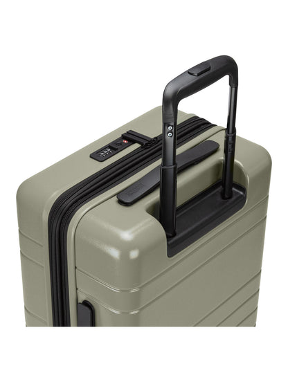 Roots Travel 19" Hardside Spinner Carry-on in sage, close-up view of extended luggage handle.