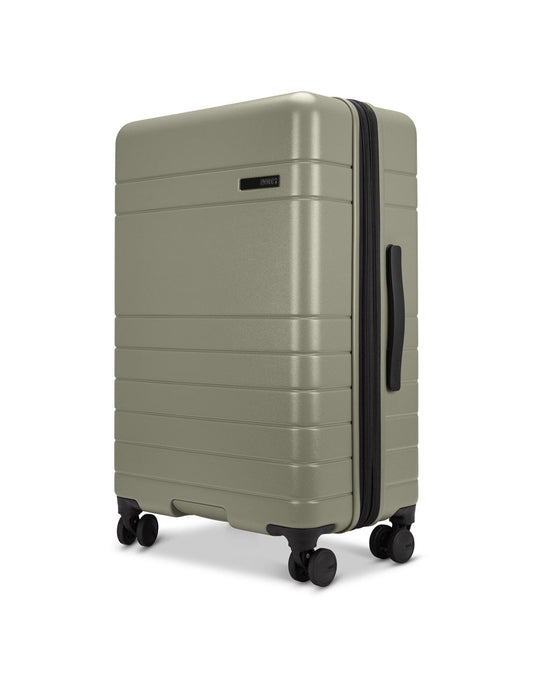 Product Image – Roots Travel 24" Expandable Hardside Spinner in sage, side angle view.