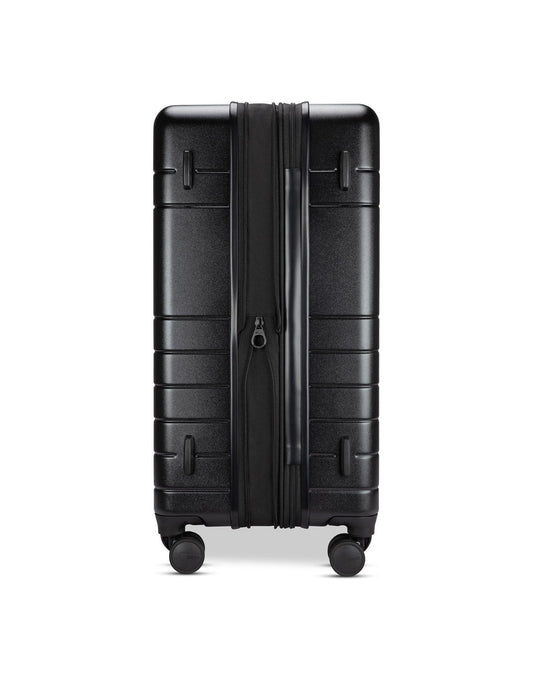 Product Image – Roots Travel 28" Expandable Hardside Spinner in black, expanded side view.