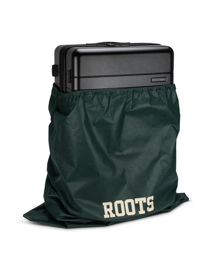 Front angle view of Roots Travel 28" Expandable Hardside Spinner in black, placed inside a Roots bag.