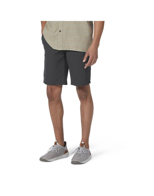 Product Image – Bottom half of man wearing Royal Robbins Men's Backcountry Pro Multi Short in charcoal grey with beige button shirt and running shoes