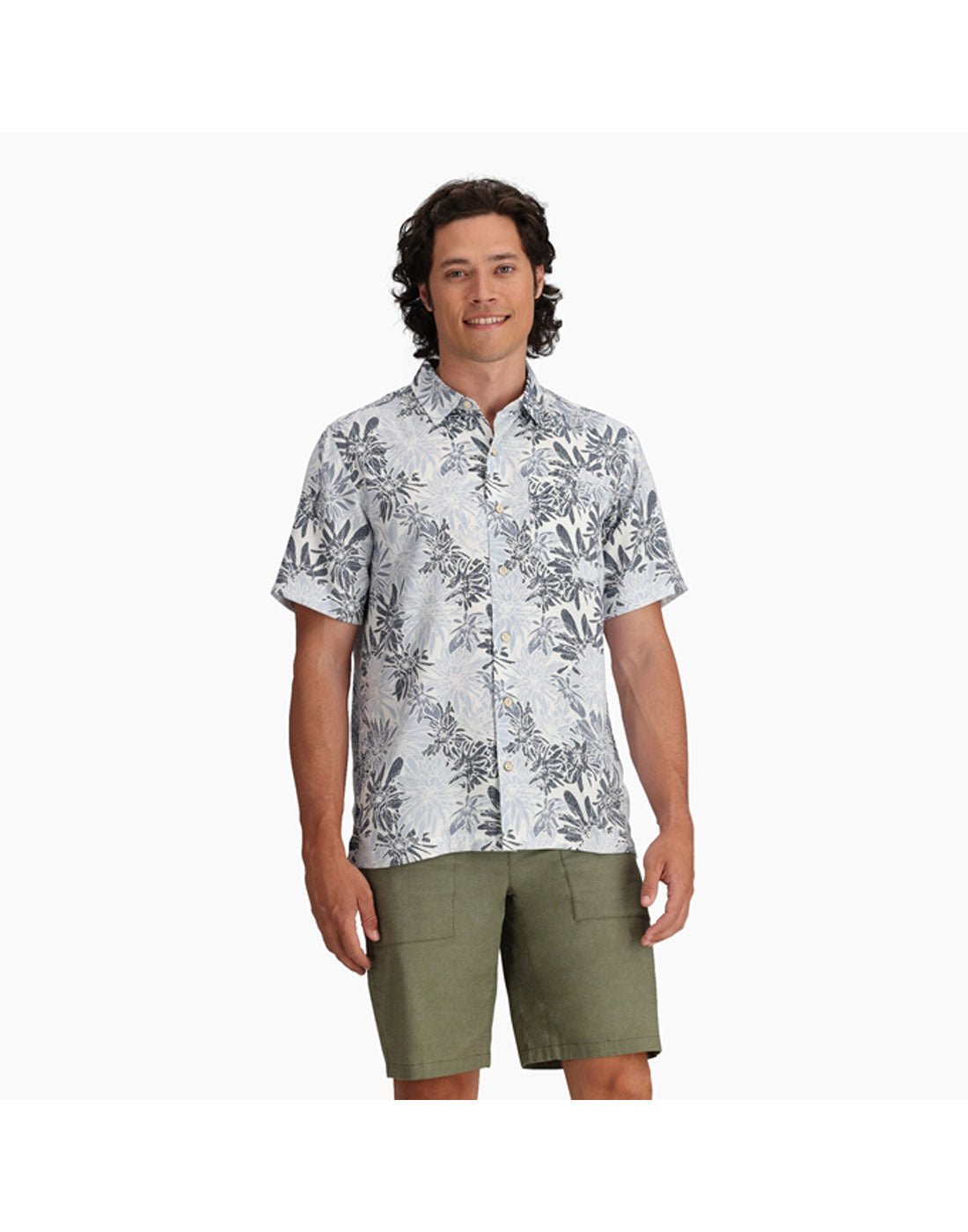 Top half of man wearing Royal Robbins Men's Comino Leaf Short Sleeve with green shorts