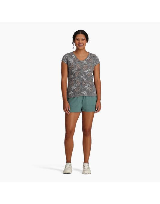 Product Image – Woman wearing Royal Robbins Women's Featherweight Tee in turbulence usla print with teal shorts and running shoes, front view