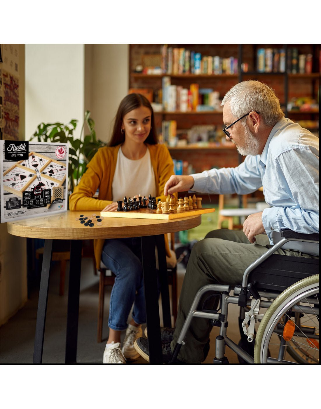 Man in wheelchair and young girl playing Rustik Crazy 4 Sling Puck Game at a table