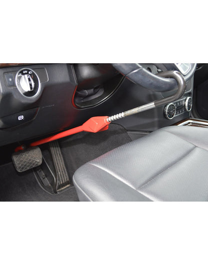 Lifestyle image of The Club® Pedal to Wheel Lock in use, one end hooked on steering wheel and other end hooked to brake pedal