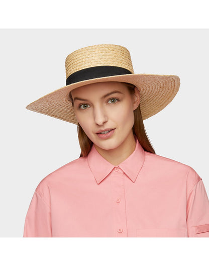 Woman wearing pink shirt and the Tilley Raffia Wide Brimmed Hat looking straight at the camera