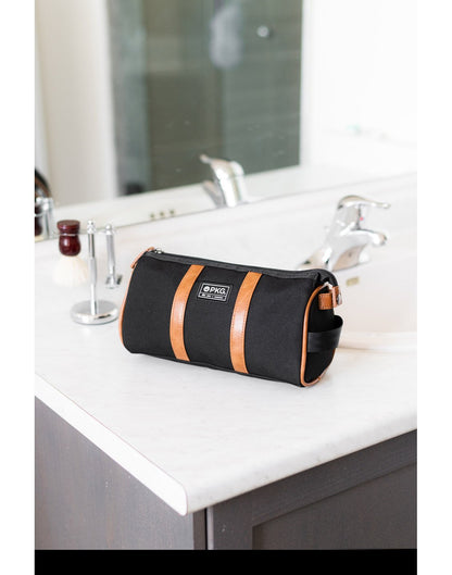 PKG Charlotte Dopp Kit in black on a bathroom vanity countertop