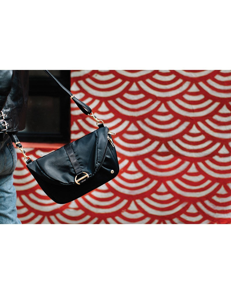 Women carrying citysafe cx convertible anti-theft black colour handbag front view
