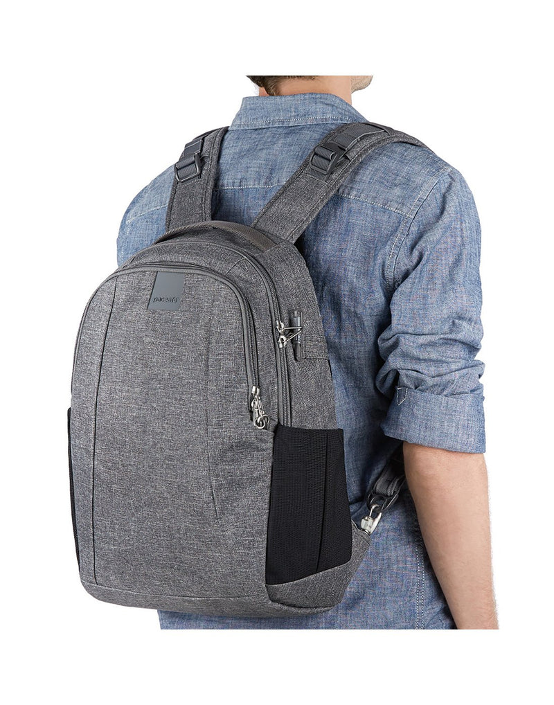 Men wearing metrosafe LS350 anti-theft 15l dark tweed colour backpack corner view