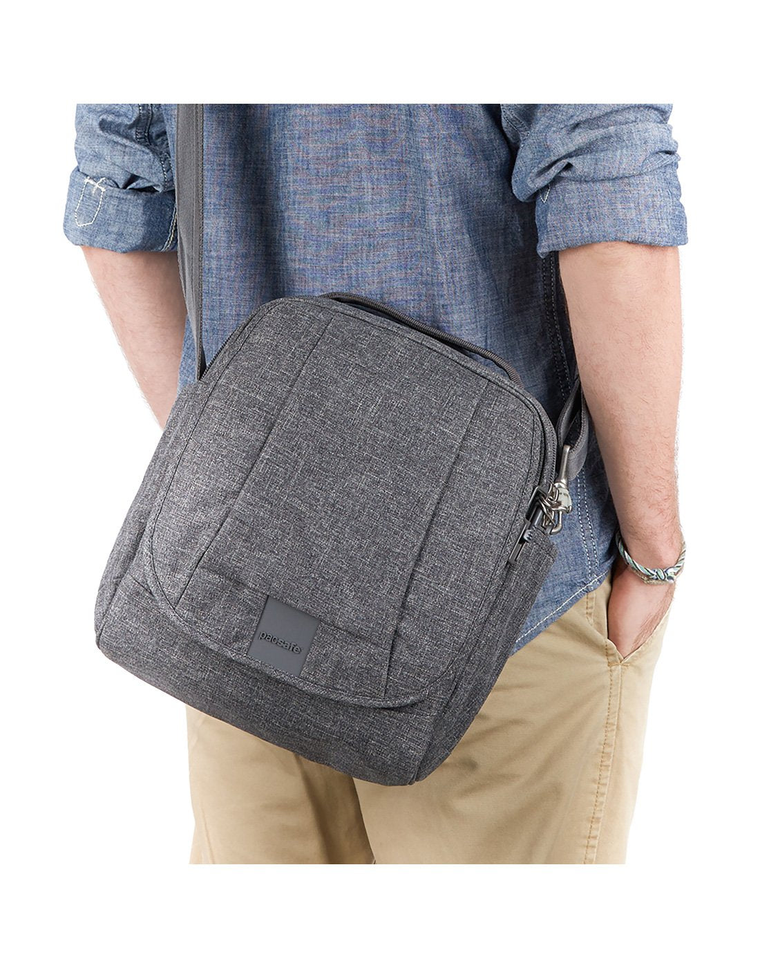 Man carrying pacsafe metrosafe ls200 anti-theft dark tweed colour shoulder bag front view