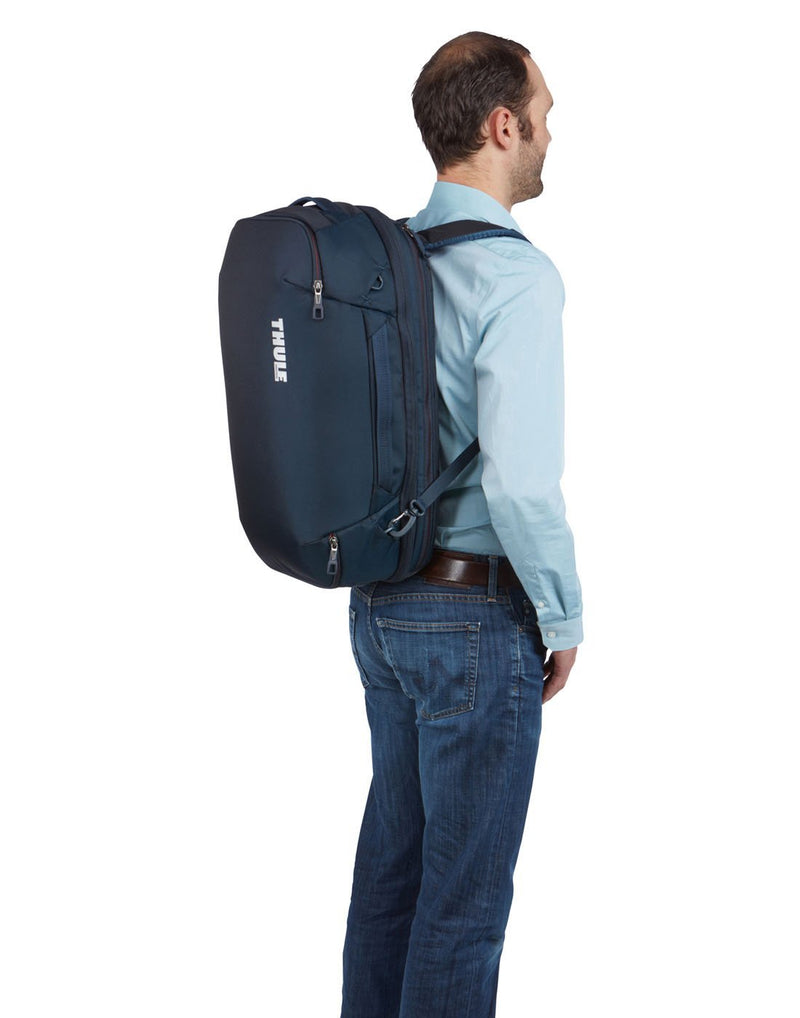 Man wearing Thule subterra carry-on 40L mineral colourbag using as backpack