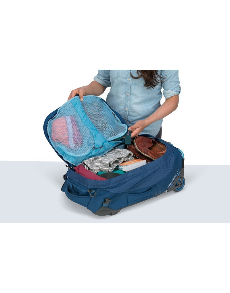 Women carrying osprey ozone 42L/21.5" buoyant blue colour luggage bag internal mesh pocket