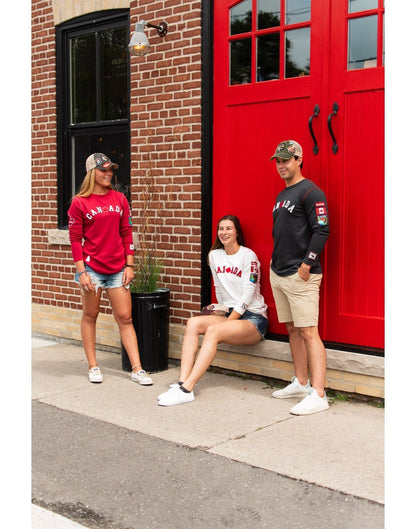 Girl wearing canada women's white long sleeve t-shirt and talking with friends