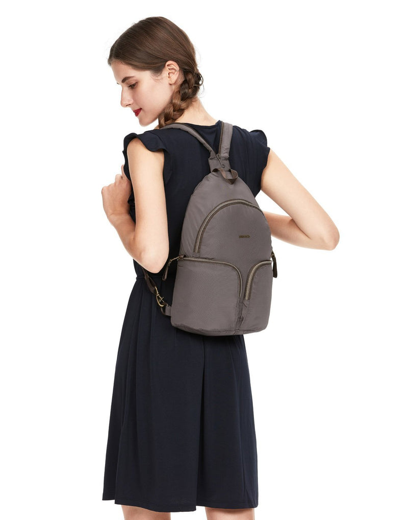 Women wearing pacsafe stylesafe anti-theft mocha colour sling backpack corner view